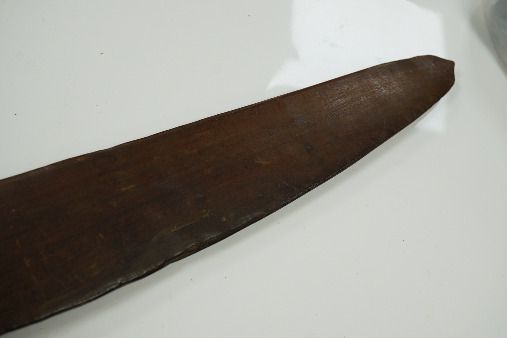 An Aboriginal boomerang, engraved to one side, 76cm wide. Condition - fair to good